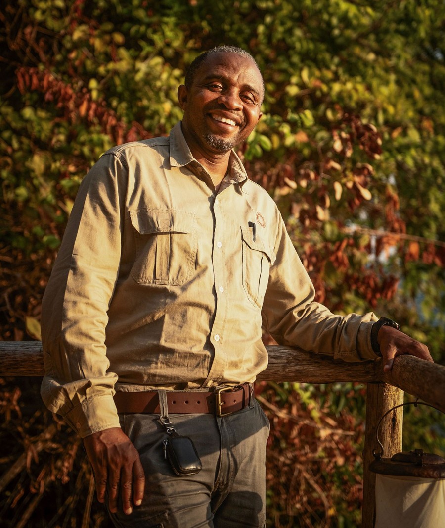 Mwiga Mambo, camp manager and chimpanzee expert at Nomad Greystoke Mahale, smiling portrait